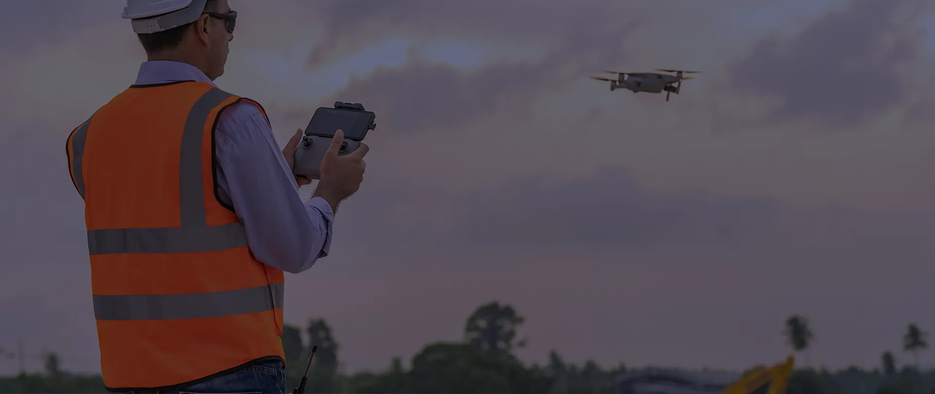 construction worker flying a drone on job site